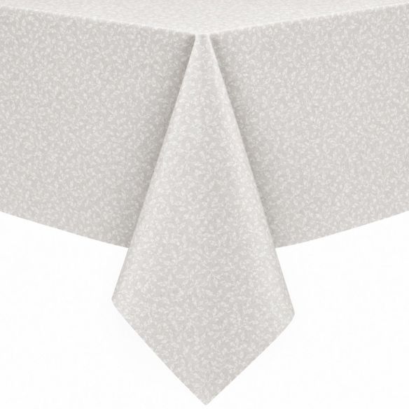 Wit gecoat tafellinnen Ribalta met een subtiel bladerpatroon, elegant gedrapeerd over een tafel voor een stijlvolle en beschermende uitstraling.