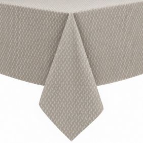 Gecoat tafellinnen Munch in beige met een subtiel wit stippenpatroon, elegant gedrapeerd over de hoek van een tafel voor een stijlvolle uitstraling.