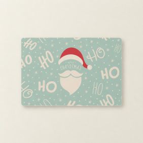 Blauwe Placemat Hohoho van 30x45cm met een kerstmanmuts, witte baard, sneeuwvlokken en de tekst Merry Christmas in een vrolijk patroon.
